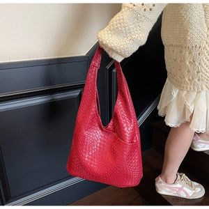 Detail of red woven leather hobo tote showing premium texture and handle design