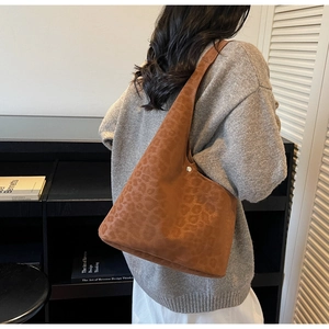 Detail of the brown leopard print suede texture on this large vintage hobo shoulder bag