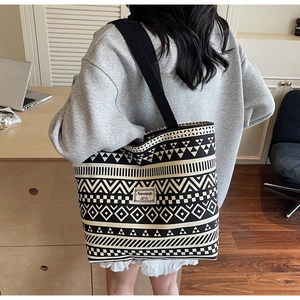 Detail of large canvas tote bag with black and white ethnic geometric patterns
