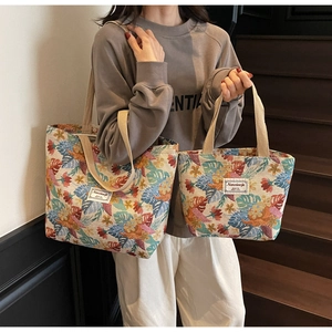 Detail of bohemian floral print tote bags in large and small sizes with brand label