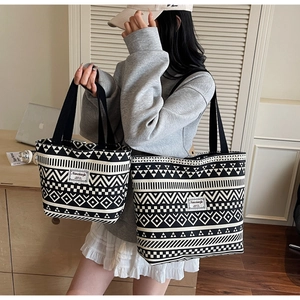 Comparison of large and small canvas tote bags with black and white geometric patterns