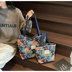 Detailed set of two ethnic tote bags with colorful tropical floral and palm leaf patterns