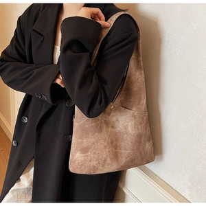 Close-up of vintage brown suede tote bag featuring high-quality matte leather texture