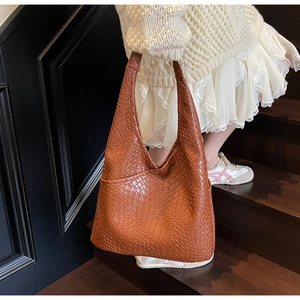 Brown woven hobo tote bag shown on model with large capacity design for women