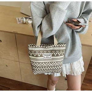 Detail of bohemian geometric pattern and brand label on large canvas tote bag