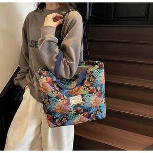Detailed close-up of large floral jacquard tote bag with vibrant botanical embroidery