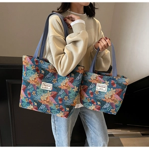 Detailed view of large and small ethnic jacquard tote bags with floral patterns