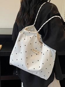 Floral canvas tote bag with drawstring mesh detail for beach vacations and daily commute