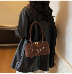 Detail view of brown leopard print Boston handbag with shoulder strap and metal zipper
