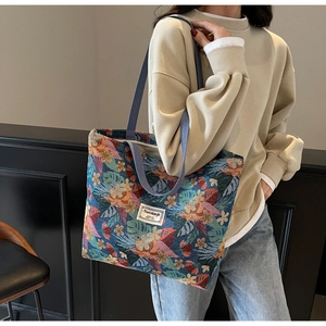 Close-up of floral jacquard fabric and brand woven label on large capacity tote bag