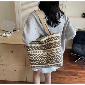 Ethnic pattern canvas tote bag detail featuring geometric prints and woven shoulder strap