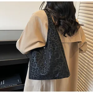 Detail of large leopard print tote bag with soft texture and magnetic metal closure