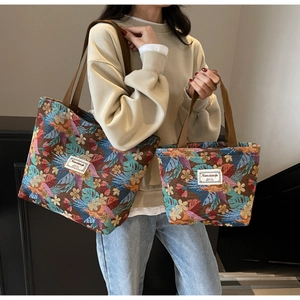 Detail of ethnic floral jacquard tote bags in two sizes with tropical leaf patterns