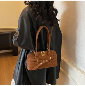 Close-up of leopard print suede boston bag with gold hardware and dual handles
