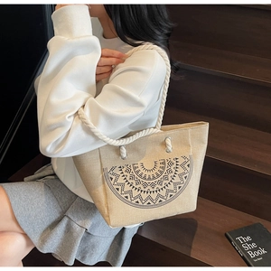 Detail of linen tote bag with geometric pattern and white cotton rope handles