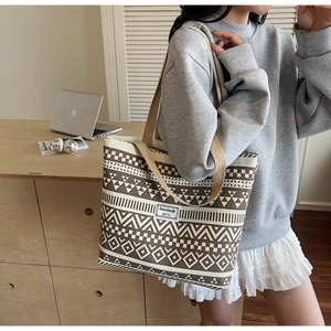 Detailed shot of large canvas tote bag with brown geometric prints and durable straps