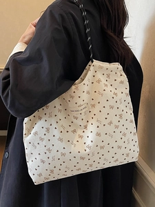 White corduroy tote bag with brown heart patterns and stylish rope handles for women