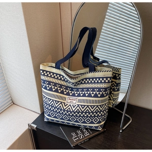 Detail view of large canvas tote bag with blue geometric bohemian patterns and dual handles