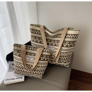Detail of two-piece canvas tote bag set featuring bohemian geometric patterns in brown