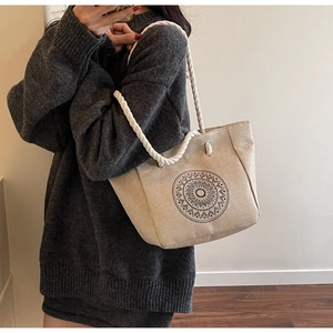 Macro shot of mandala printed linen tote bag featuring braided cotton rope handles