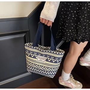 Detail of canvas tote bag with geometric patterns and Nanxiaojie brand label