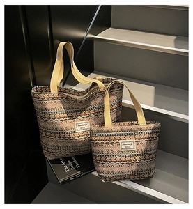 Macro detail of ethnic pattern jacquard fabric and sturdy straps on two tote bags