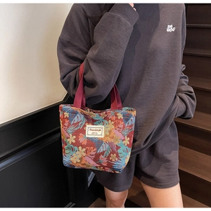 Detailed texture of ethnic tote bag with vintage leaf pattern and fabric label