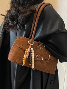 Brown retro crossbody bag with colorful beads shown on black leather jacket outfit