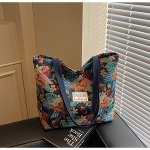 Detailed macro of floral canvas tote bag with colorful tropical botanical print patterns