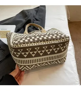 Close-up of geometric canvas tote bag with striped patterns and thick woven handles