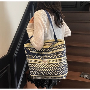 Canvas tote bag with blue ethnic patterns and Nanxiaojie label on a model's shoulder