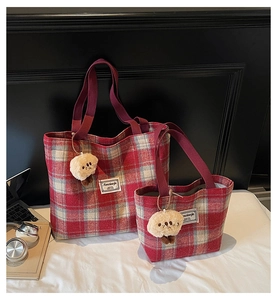 Detail of red and white checkered tote bags in two sizes with cute plush doll charms