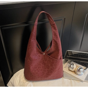Detail of burgundy leopard print hobo tote bag with matte finish and wide strap