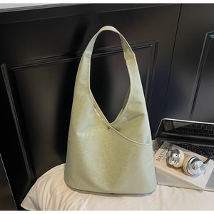 Close-up of light green hobo bag with subtle leopard print and silver buckle detail