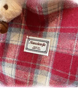 Close-up of red and white checkered fabric with stitched Nanxiaojie brand label