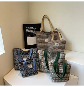 Close-up of geometric jacquard tote bags in brown, blue and green with canvas handles