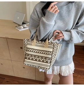 Close-up of bohemian geometric patterns on a durable canvas tote bag held by a model