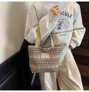 Detail shot of ethnic geometric woven pattern and brand label on oversized canvas tote bag