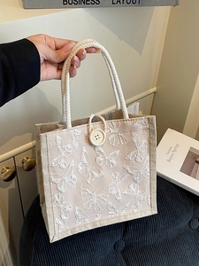 Elegant cream tote bag featuring 3D butterfly patterns and rope handles for daily use
