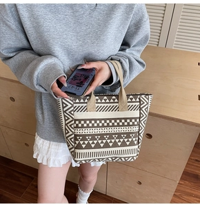 Close-up of geometric pattern canvas tote bag with ethnic motifs and reinforced handles