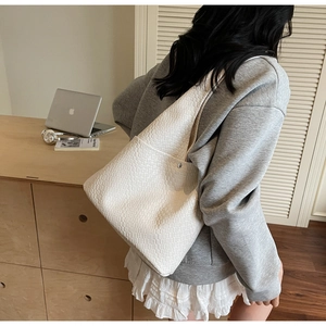 Detail view of woven white tote bag texture with magnetic closure for daily commute