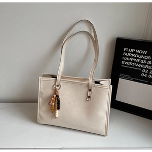 Close-up of leopard pattern texture on cream tote bag with stylish wooden bead charm