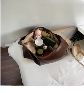 Detailed interior of large brown tote bag showing spacious capacity for daily essentials