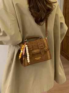Vintage brown leopard print crossbody bag with gold studs and decorative beads on shoulder