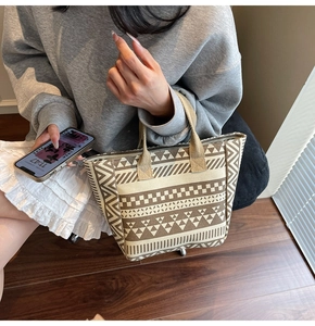 Detail of geometric pattern canvas tote bag showing tribal triangles and checkerboard texture