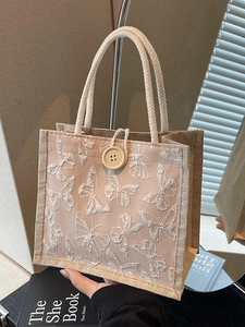 Chic beige burlap tote bag with pink butterfly embroidery and white braided handles