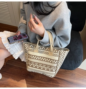 Detail of geometric pattern canvas tote bag with textured straps and ethnic design