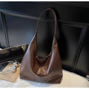 Detail of soft dark brown leather hobo bag with vintage texture and large capacity