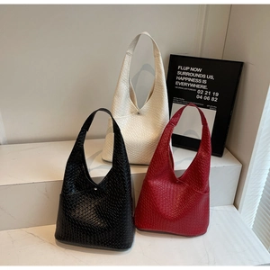 Three large woven tote bags in black, ivory, and red with silver magnetic buckles