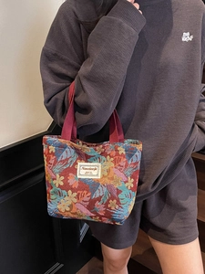 Ethnic style jacquard tote bag with colorful floral patterns and burgundy handles